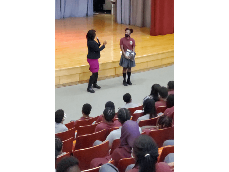 a woman and a student on stage